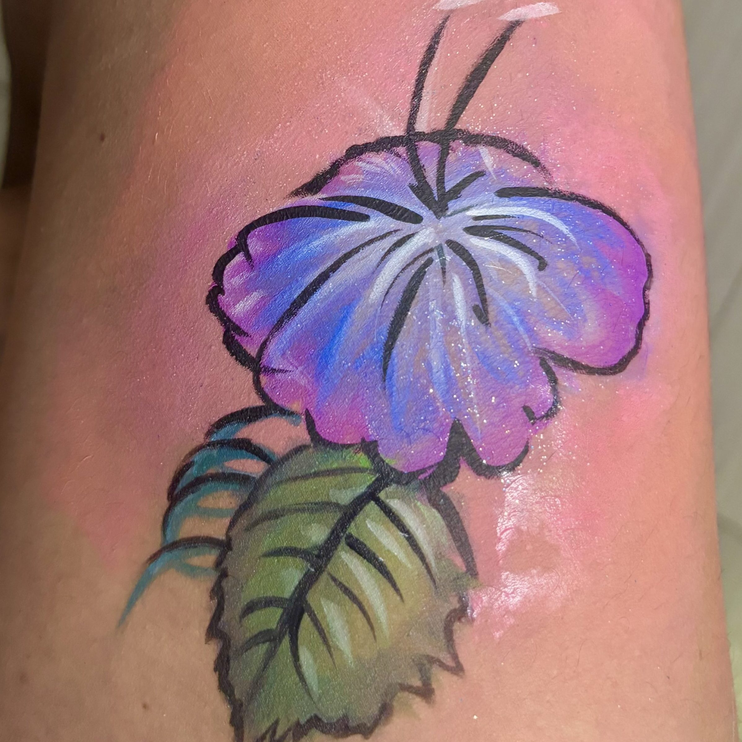 Painted Image of a blue and purple hibiscus-style flower with a green leaf.